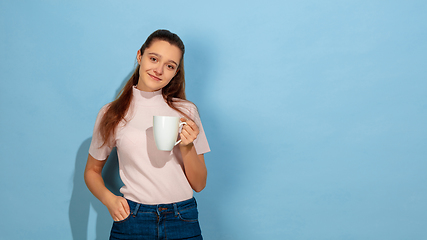 Image showing Caucasian teen girl portrait isolated on blue studio background