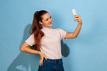 Image showing Caucasian teen girl portrait isolated on blue studio background