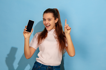 Image showing Caucasian teen girl portrait isolated on blue studio background