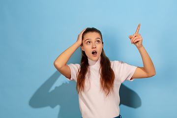 Image showing Caucasian teen girl portrait isolated on blue studio background