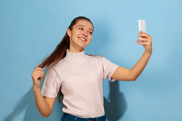 Image showing Caucasian teen girl portrait isolated on blue studio background