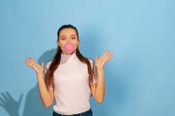 Image showing Caucasian teen girl portrait isolated on blue studio background