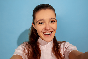 Image showing Caucasian teen girl portrait isolated on blue studio background