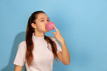 Image showing Caucasian teen girl portrait isolated on blue studio background