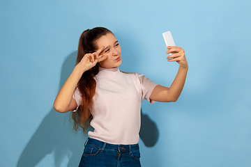 Image showing Caucasian teen girl portrait isolated on blue studio background