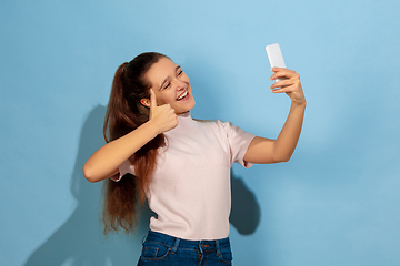 Image showing Caucasian teen girl portrait isolated on blue studio background