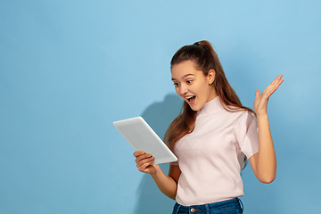 Image showing Caucasian teen girl portrait isolated on blue studio background