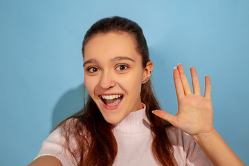 Image showing Caucasian teen girl portrait isolated on blue studio background