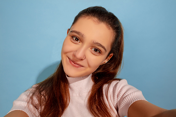 Image showing Caucasian teen girl portrait isolated on blue studio background