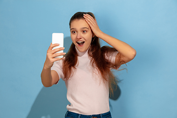 Image showing Caucasian teen girl portrait isolated on blue studio background