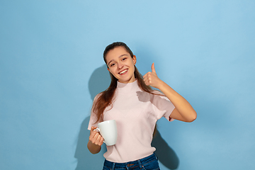 Image showing Caucasian teen girl portrait isolated on blue studio background