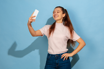 Image showing Caucasian teen girl portrait isolated on blue studio background