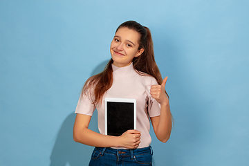 Image showing Caucasian teen girl portrait isolated on blue studio background