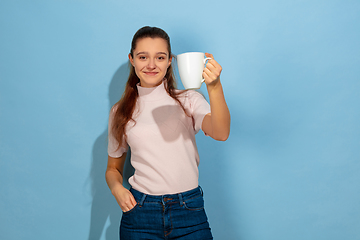 Image showing Caucasian teen girl portrait isolated on blue studio background