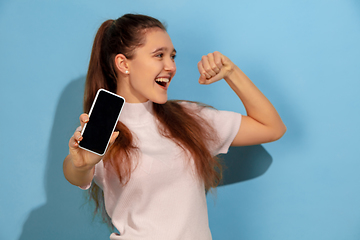 Image showing Caucasian teen girl portrait isolated on blue studio background