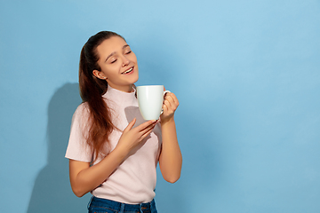 Image showing Caucasian teen girl portrait isolated on blue studio background