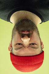 Image showing Inverted portrait of caucasian young man on yellow studio background