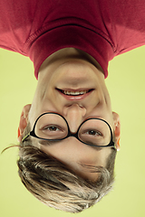 Image showing Inverted portrait of caucasian young man on yellow studio background