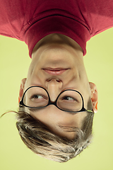 Image showing Inverted portrait of caucasian young man on yellow studio background