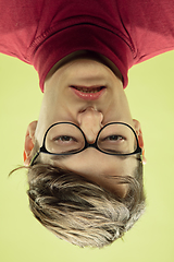 Image showing Inverted portrait of caucasian young man on yellow studio background