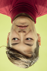 Image showing Inverted portrait of caucasian young man on yellow studio background