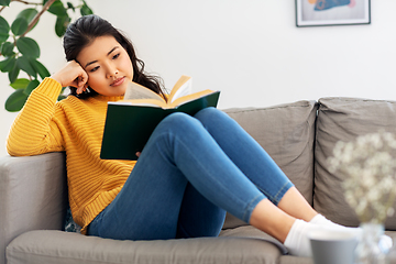 Image showing asian young woman reading book at home