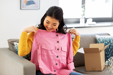 Image showing happy asian young woman with parcel box at home