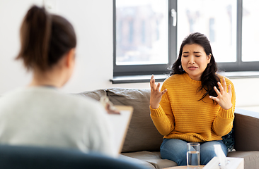 Image showing woman patient and psychologist at psychotherapy