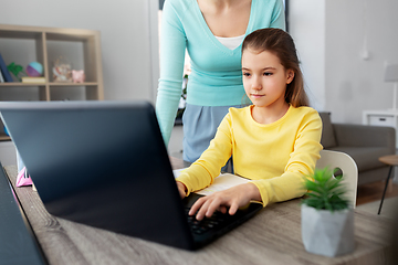 Image showing mother and daughter with laptop doing homework