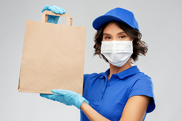 Image showing delivery woman in face mask with food in paper bag