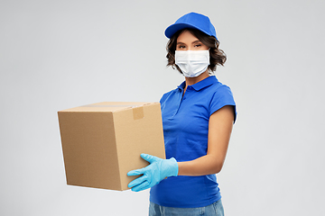 Image showing delivery woman in face mask holding parcel box