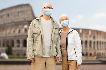 Image showing senior couple in protective medical masks in italy