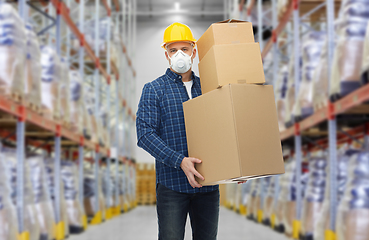 Image showing worker in respirator mask with boxes at warehouse