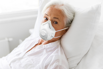 Image showing old woman in respirator lying in bed at hospital