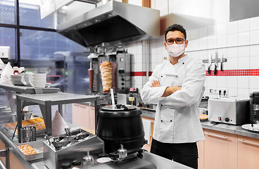 Image showing male chef with in face mask at kebab shop kitchen