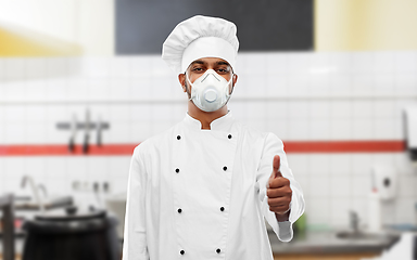 Image showing chef in respirator showing thumbs up at kitchen