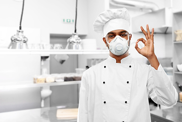 Image showing chef in respirator showing ok sign at kitchen