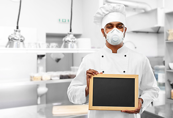 Image showing chef in respirator with chalkboard at kitchen