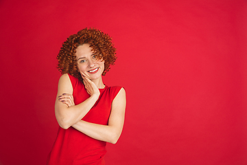 Image showing Caucasian woman\'s portrait isolated over red studio background with copyspace