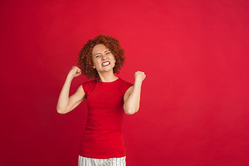 Image showing Caucasian woman\'s portrait isolated over red studio background with copyspace