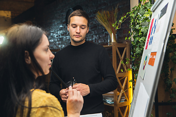 Image showing Colleagues working together in modern office using flipchart during creative meeting