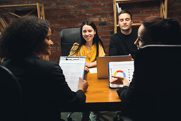 Image showing Colleagues working together in modern office using devices and gadgets during creative meeting