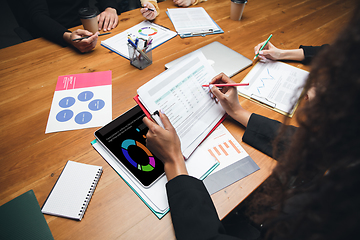 Image showing Colleagues working together in modern office using devices and gadgets during creative meeting