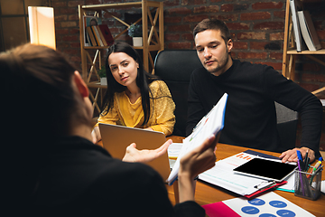 Image showing Colleagues working together in modern office using devices and gadgets during creative meeting