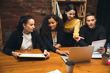 Image showing Colleagues working together in modern office using devices and gadgets during creative meeting