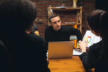 Image showing Colleagues working together in modern office using devices and gadgets during creative meeting