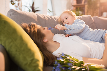 Image showing Family time. Mother and daughter having time together at home, look happy and sincere