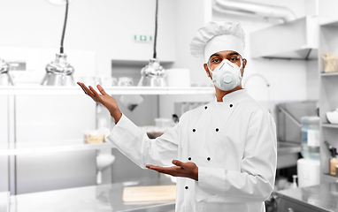 Image showing male chef in respirator at restaurant kitchen