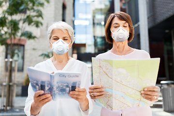 Image showing senior women with city guide and map in face masks