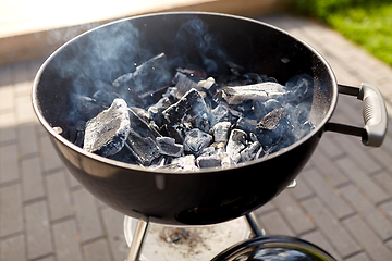 Image showing charcoal smoldering in brazier outdoors